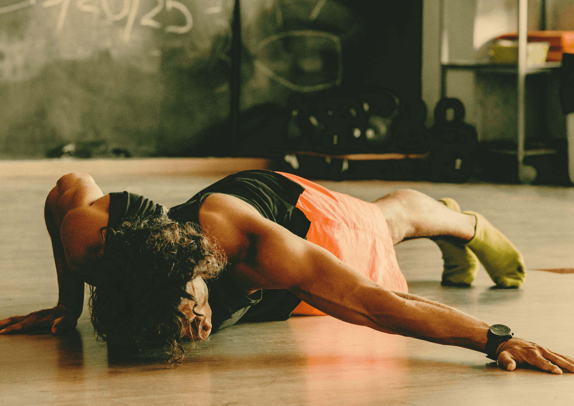 A man doing a side push up on the floor