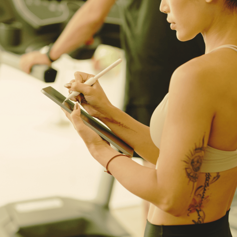 A woman tracking progress on a notepad